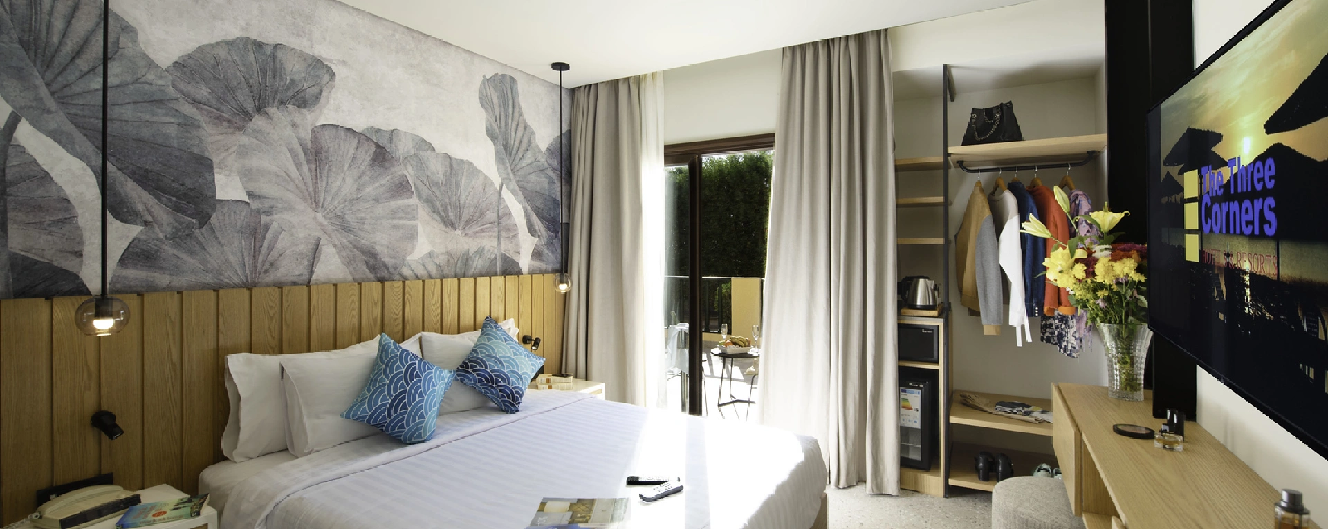 Elegant hotel room at night featuring a king-size bed, a sleek TV, and open balcony curtains that allow a glimpse of the nighttime ambiance outside. The interior is beautifully decorated with stylish furnishings and soft lighting, creating a cozy and sophisticated atmosphere.