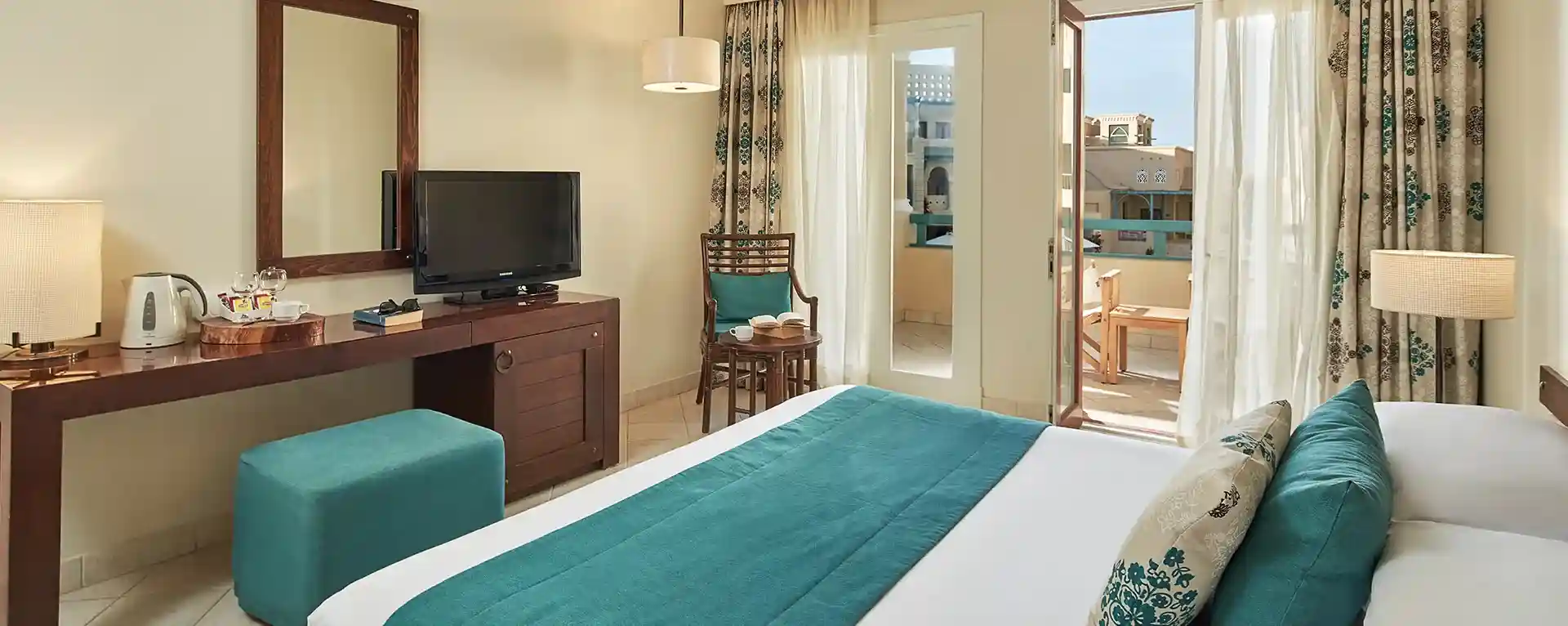 Hotel room featuring a king-sized bed and open curtains, inviting natural light into the serene space.