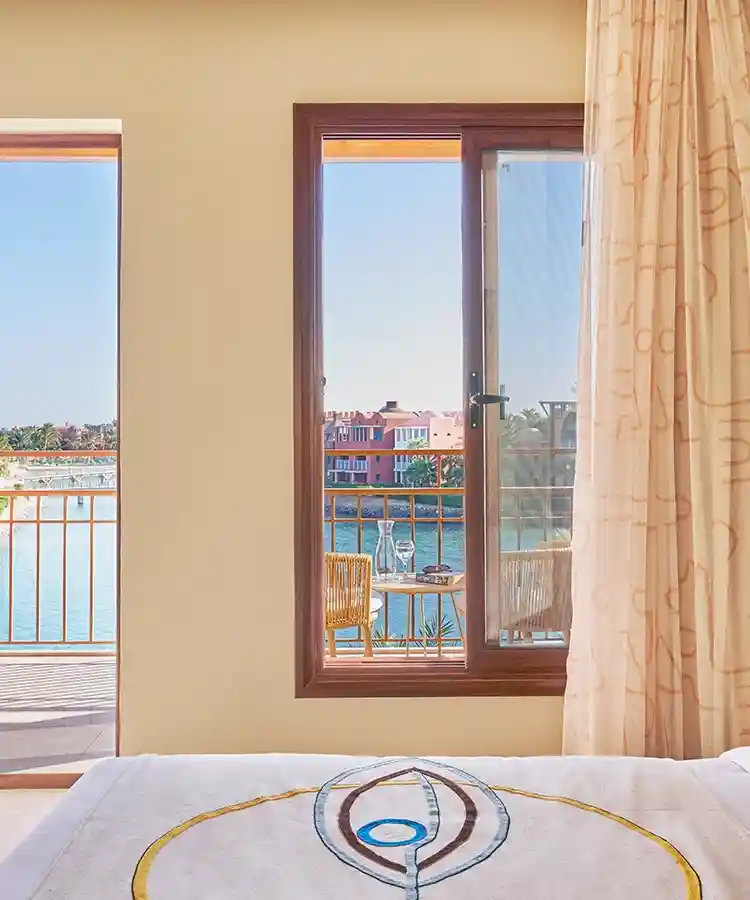 Room interior with open balcony offering a view of the lagoon below.