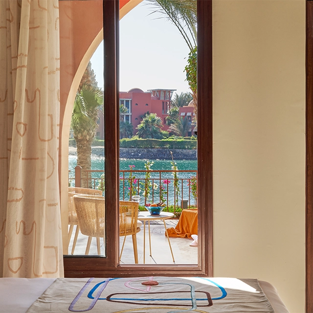 A room at Three Corners -Ocean View with an open balcony offering a picturesque view of the lagoon.