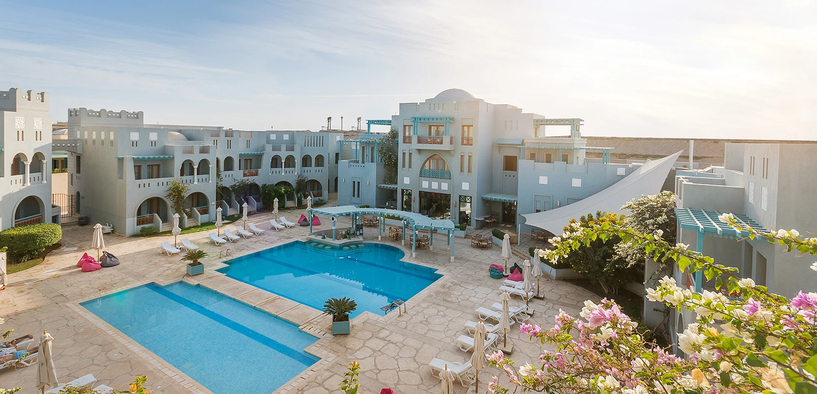 View of two pools and seating areas for guests at Fanadir Hotel, El Gouna.