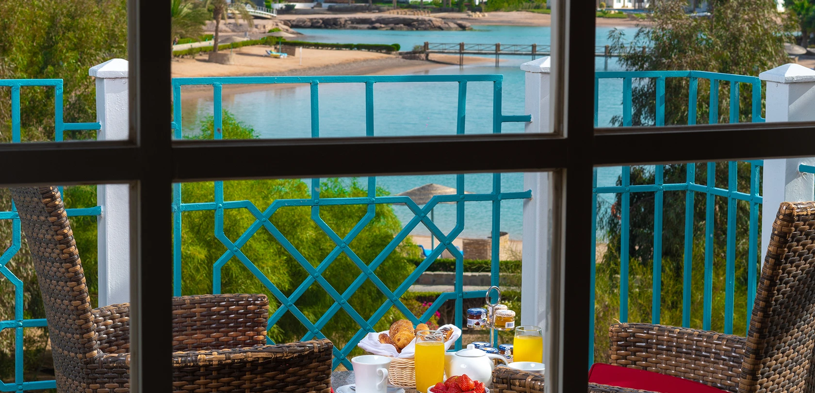 Breakfast served on a balcony with a view, featuring a spread of delicious food and beverages.
