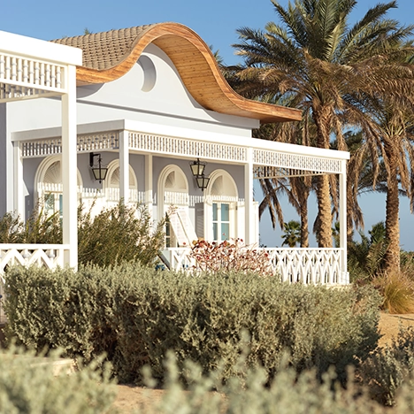 Exterior view of a beachfront suite at La Maison Bleue El Gouna, showcasing elegant architecture.