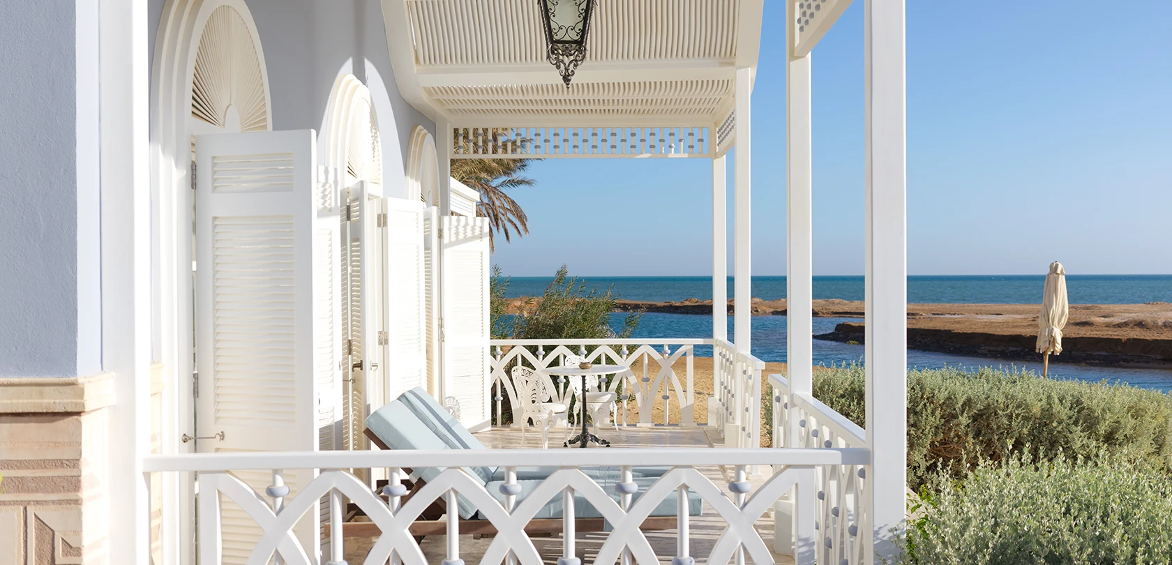 Terrace of a beachfront suite overlooking the Red Sea at La Maison Bleue El Gouna, offering a tranquil and picturesque view.