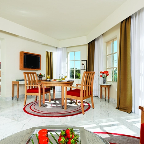 A deluxe suite at Mövenpick El Gouna in the Red Sea, offering luxurious accommodations with elegant décor and premium amenities