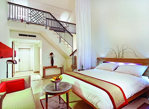 A duplex family room at Mövenpick El Gouna in the Red Sea, featuring modern amenities and a comfortable layout.